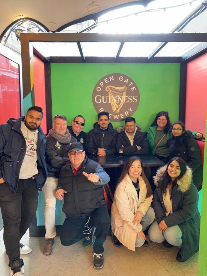 people with guinness logo in background