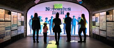 Group of Visitors enjoying an interactive Notorious Irish Exhibition at Epic Ireland 