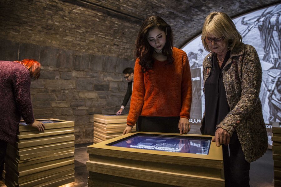 Two women enjoying an interactive exhibit at Epic Emigration Museum