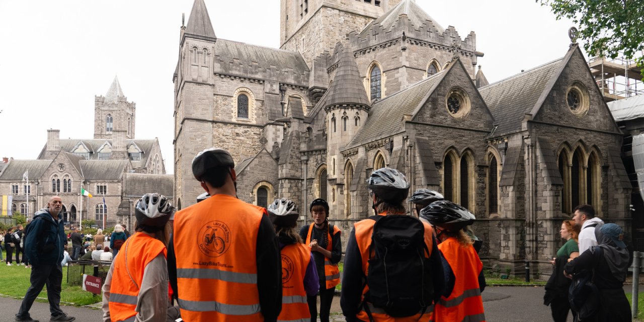 group of people looking at church with helmets on 