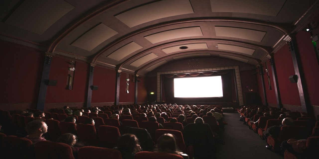 large theatre with people sitting in multiple rows