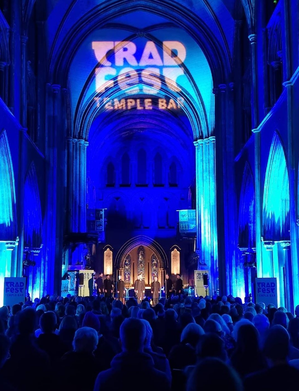 church lit up in blue with people inside 