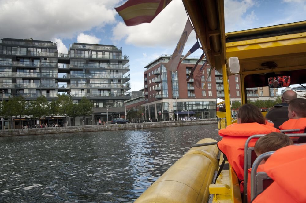 Humans on a boat in the Grand Canal Dock