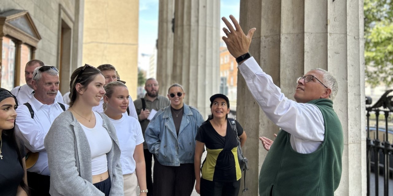 guide looking up at building