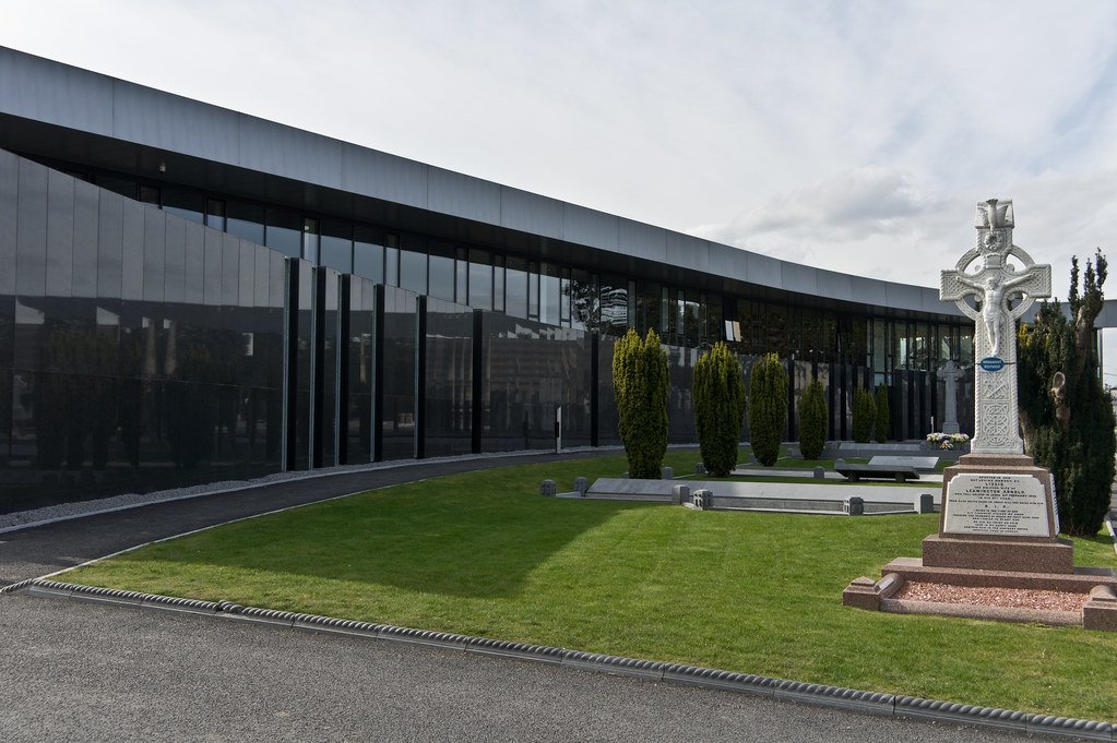 glass building with stone cross