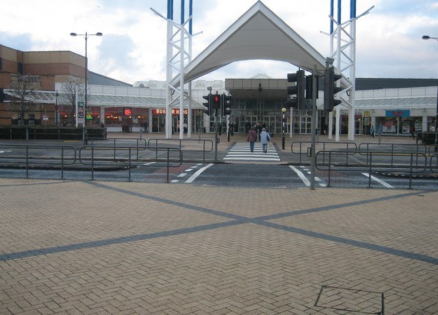 shopping centre with people walking into it 