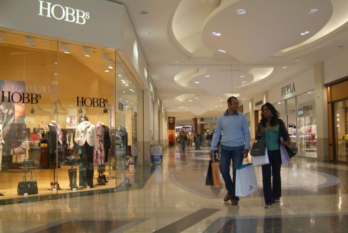 shopping centre with man and woman walking in it 