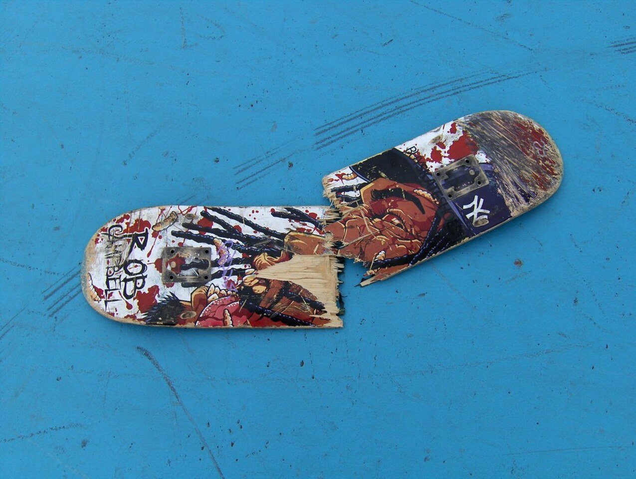 blue background, skateboard, graphiti,black spots