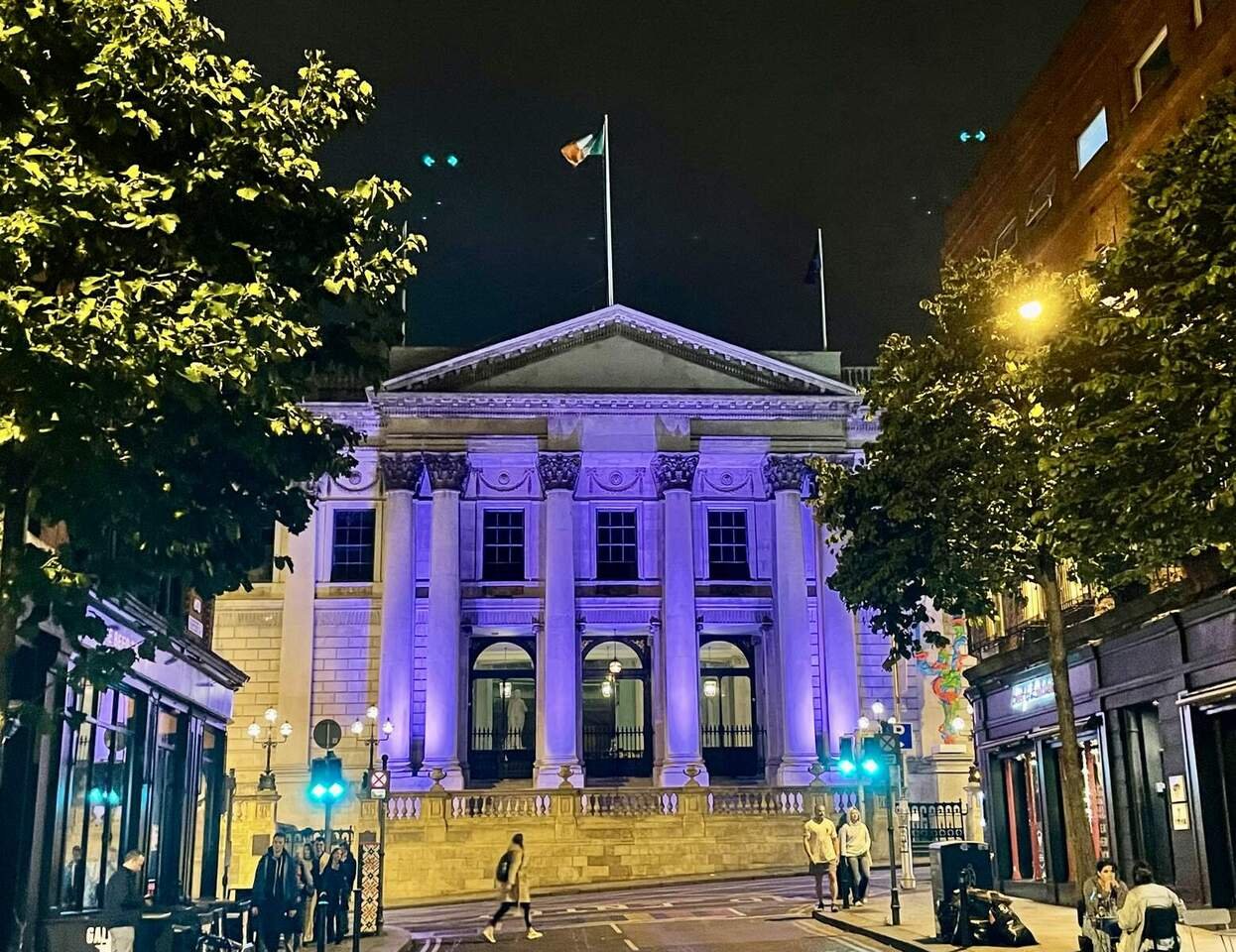 Purple lighting|Irish flags|Pillars|traffic Liights|building