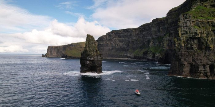 cliffs of moher by Doolin Ferry boat sailing by cliffs of moher