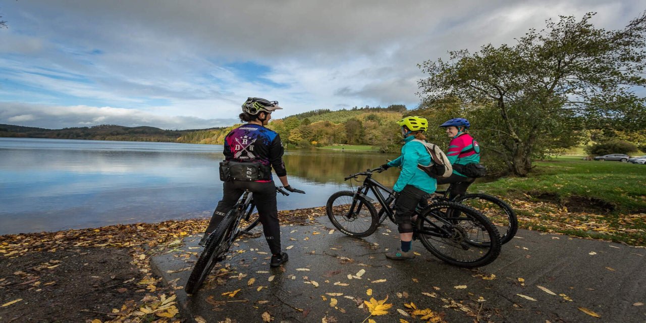 3 bikes at the bank of a river