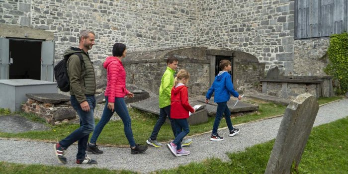 Medieval Mile Museum, Kilkenny City Courtesy Failte Ireland family of 5 walking beside stone building