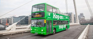 Green DoDublin Hop On Hop Off Tour crossing Samuel Beckett Bridge