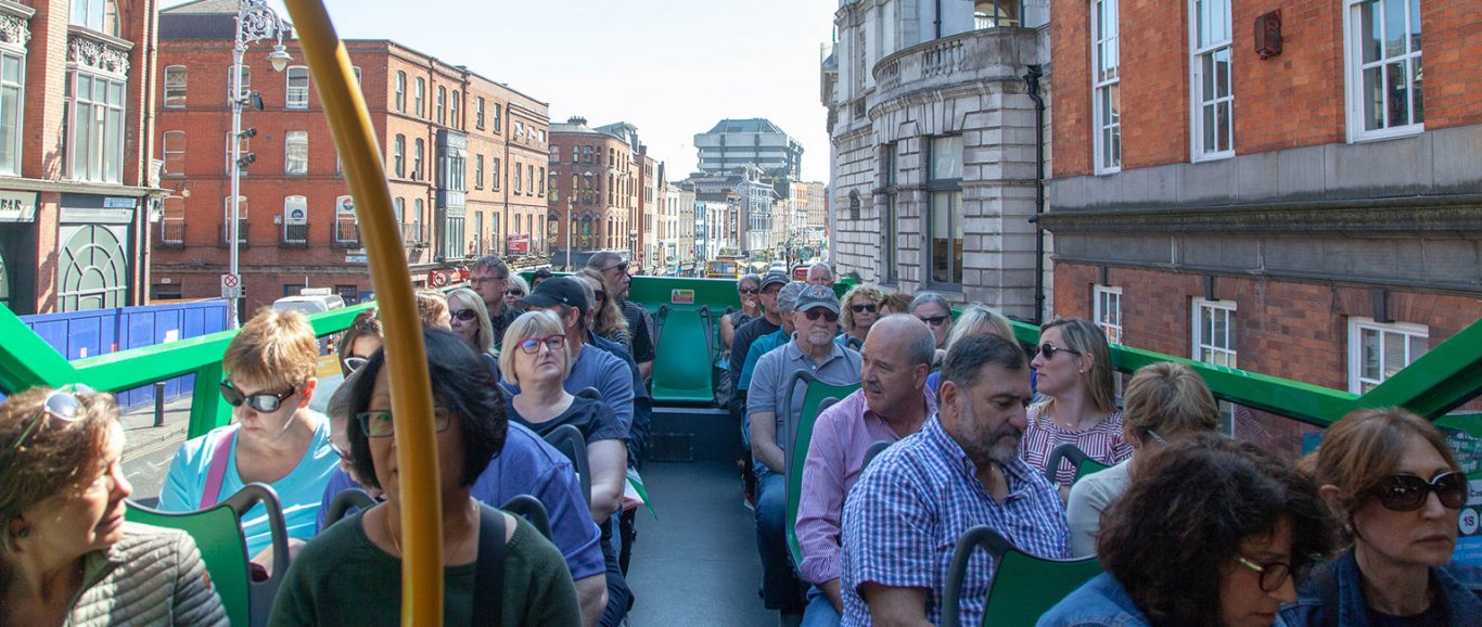 Passengers on open top bus