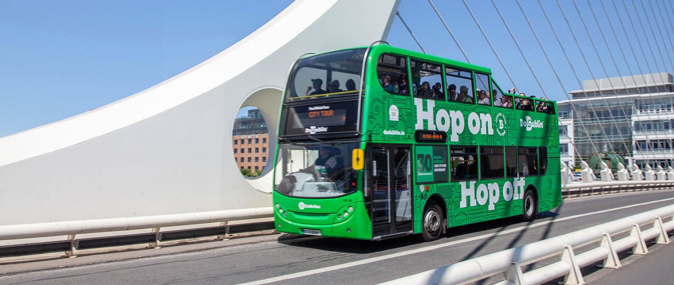 DoDublin Bus on Beckett bridge with a blue cloudless sky