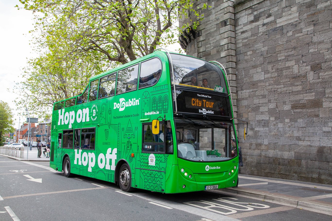 DoDublin Tour bus parked in front high prison wall, Dublin