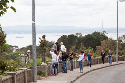 DoDublin Bus Tour Customers taking pictures from Howth Head looking towards Dublin Bay