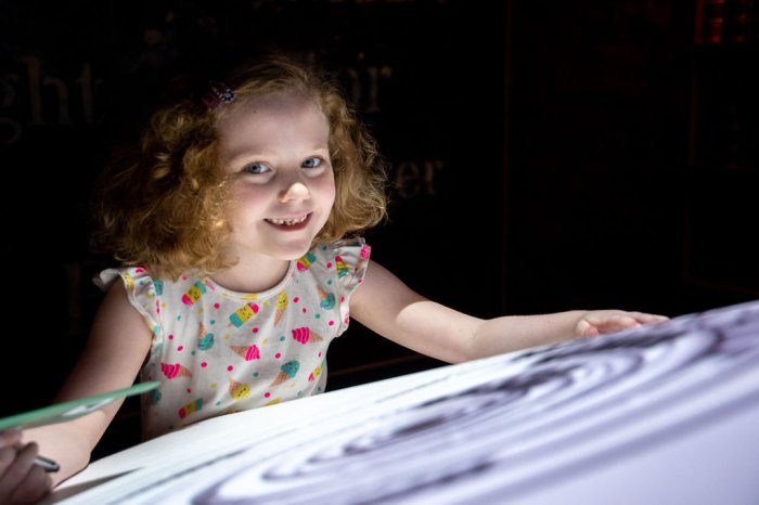 girl in front of light up screen