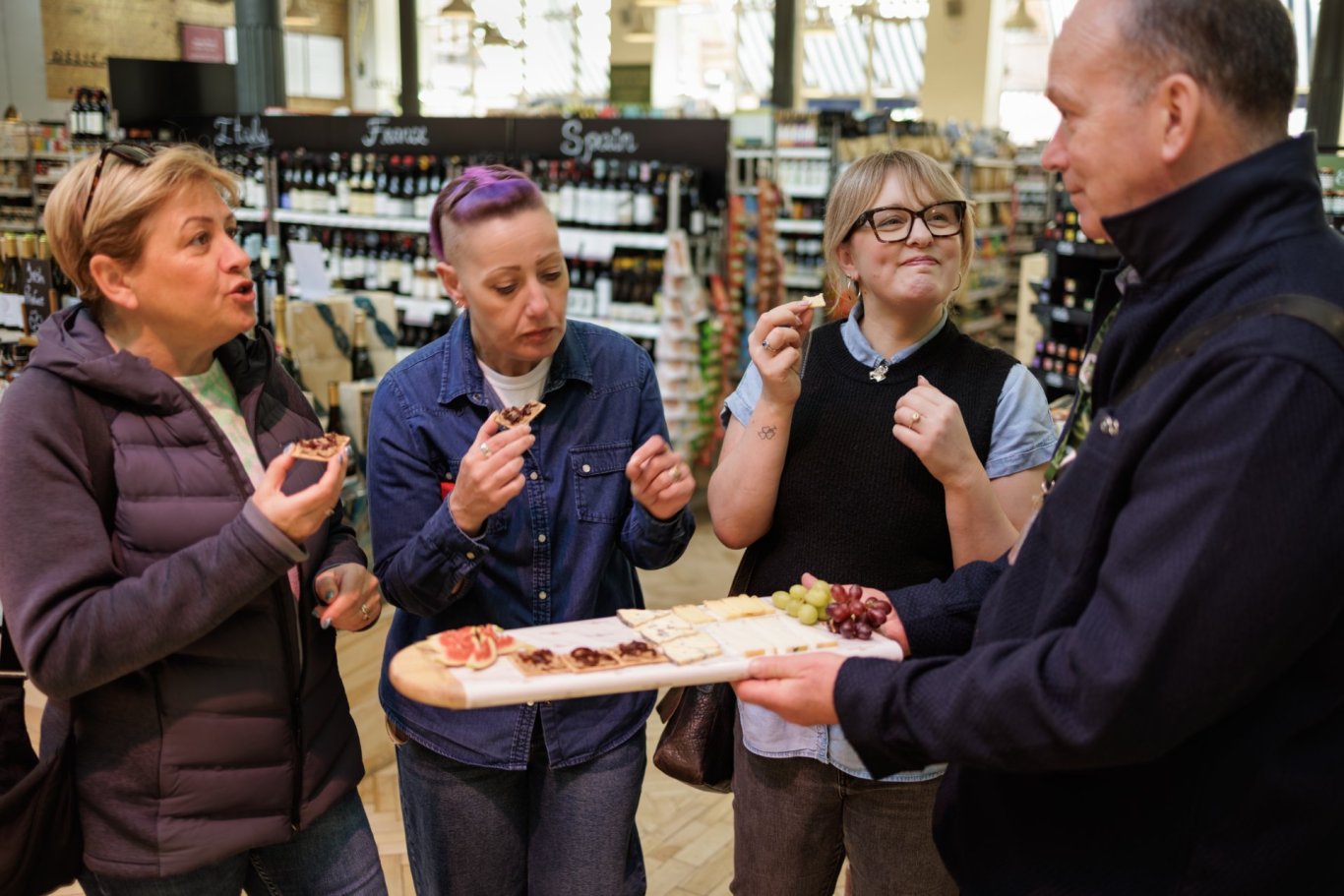 Taste Trail tasting 4 people-tasting-food-blonde-hair-purple-hair-navy-suit-meats-board