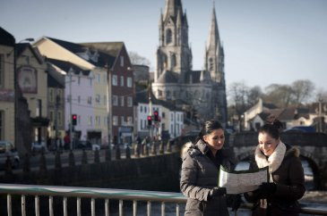 Two friends look at a map while sightseeing in Cork