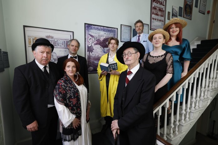 Tour guides in James Joyce Centre people dressed in old fashioned clothing on a stairs