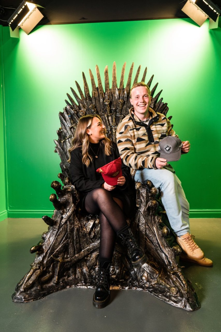 people sitting on thrones on front of green screen