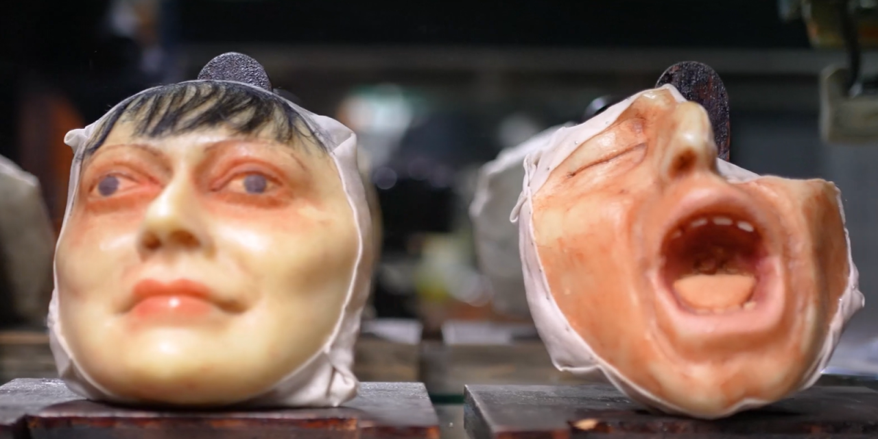 two plastic doll heads