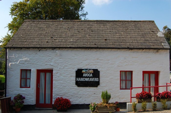 white cottage with avoca handweavers on the wall 