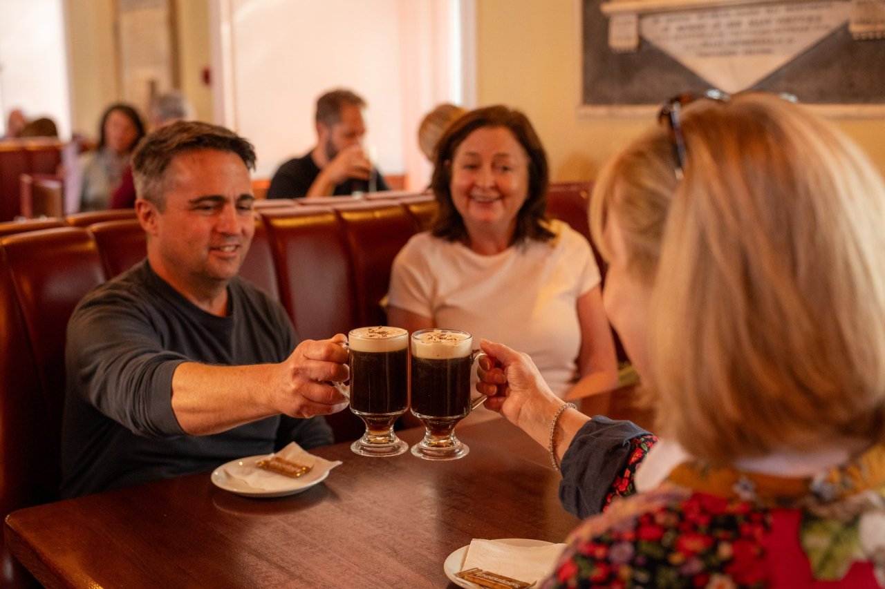 friends raising irish coffee