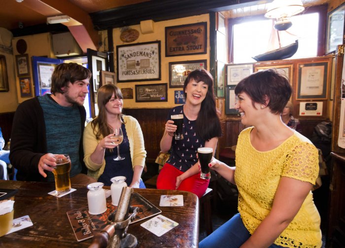 people drinking guinness in irish pub